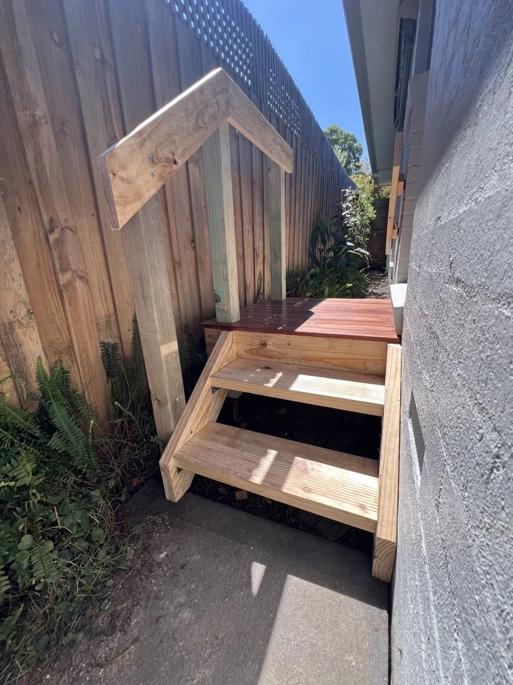 Completed timber deck, steps and handrail in a narrow side passage